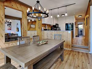 a dining room and kitchen with a wooden table and chairs at 1849 Condos 542 condo in Mammoth Lakes