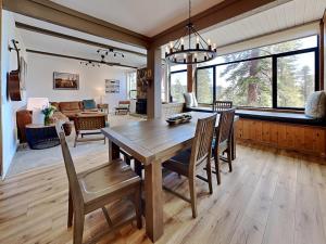a dining room and living room with a wooden table and chairs at 1849 Condos 542 condo in Mammoth Lakes +40 photos