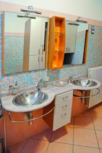 zwei Waschbecken im Bad mit zwei Spiegeln in der Unterkunft Apartments Domalu in Zadar + 37 Fotos