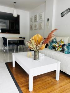 a white coffee table in a living room at Unique apartment with direct sea view along the beach in S'Abanell Central Park Blanes in Blanes