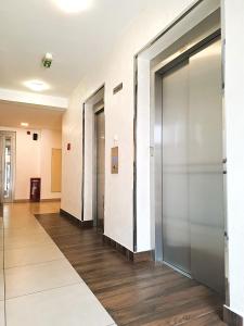 an empty hallway with elevator doors in a building at Apartment Tatiana in Belgrade