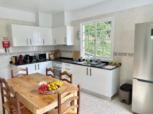 a kitchen with a table with a bowl of fruit on it at Honey Factory House in Santa Cruz