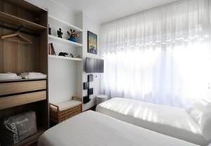 a small bedroom with a bed and a window at "Suite Sempione Park" 2 bedrooms - 2 bathrooms in Milan
