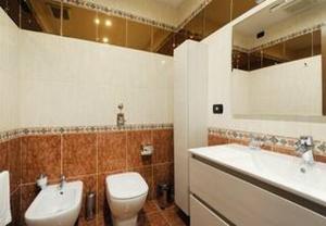 a bathroom with a toilet and a sink at "Suite Sempione Park" 2 bedrooms - 2 bathrooms in Milan +7 photos