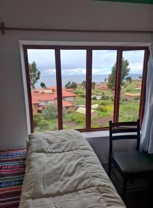 Ένα ή περισσότερα κρεβάτια σε δωμάτιο στο kaypi rosas wasi Amantani