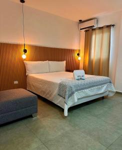 a bedroom with a bed with a laptop on it at Hotel Tunco Lodge in La Libertad +104 photos