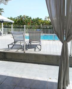 two chairs sitting on a porch next to a pool at Golf Marin in Saint-François