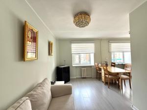 a living room with a couch and a dining room at Urban Suites Spacious 2-Bedroom Apartment in Taryaatayn Baraanii Bayshing +11 photos