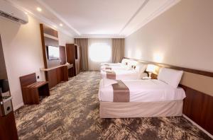 Ένα ή περισσότερα κρεβάτια σε δωμάτιο στο فندق ثمره اليقين