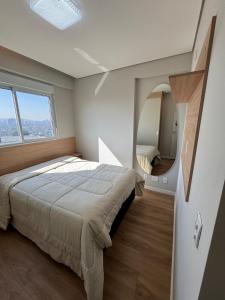 a bedroom with a large bed and a mirror at New apartment in Bethaville, comfortable, Barueri in Barueri