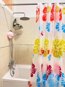a shower curtain in a bathroom with a tub at Peaceful and Spacious Apartment at Luanda Bay in Luanda +58 photos