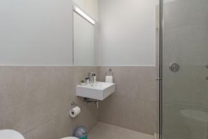 a bathroom with a toilet and a sink and a shower at Walk to Beach, Fast WiFi, Discounted, Nightlife in Kirstenhof +8 photos