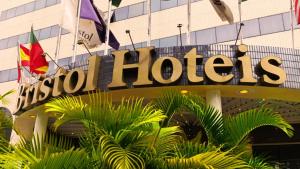 a hotel sign in front of a building at GRU Airport Hotel - STAY HERE in Guarulhos