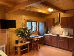 a kitchen with a table and a refrigerator at Bałtycka Oaza in Debina