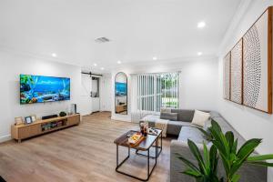 a living room with a couch and a table at WOW! Pickleball - Gym - Stylish Modern Living in Valrico