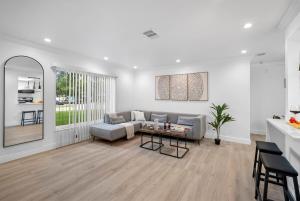 a living room with a couch and a table at WOW! Pickleball - Gym - Stylish Modern Living in Valrico