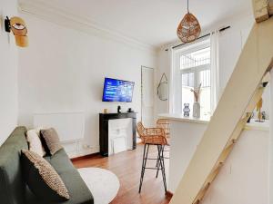 a living room with a couch and a fireplace at Charming Studio 1BR-2P - Batignolles in Paris