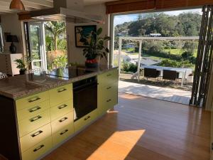 a kitchen with yellow cabinets and a view of a patio at Forty9 Steps in Russell