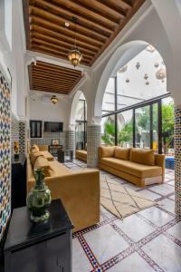 a living room with couches and a table at Riad Dar Dialkoum in Marrakech