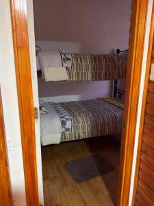 a room with two bunk beds and a door open at Cabaña en Curacautin in Curacautín