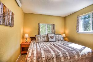 a bedroom with a bed and two windows at New Listing 3bd Woodsy Vibe in Leadville in Leadville