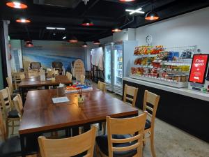 a restaurant with wooden tables and chairs and a counter at Five hotel Jongno in Seoul