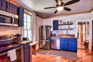 a kitchen with blue cabinets and a ceiling fan at Rustic & Cozy 1BR one block from Main Street in Leadville