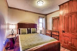 a bedroom with a large bed with a wooden headboard at Rustic & Cozy 1BR one block from Main Street in Leadville +13 photos