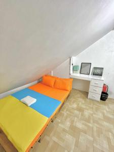 a small room with a bed and a desk at Nomads MNL Backpackers Homestay - near Airport in Manila +57 photos