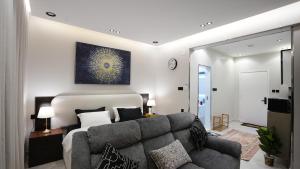 a living room with a couch and a bed at Lavender Studio Apartment by Wandernest Suites with Comfy Recliners in Riyadh