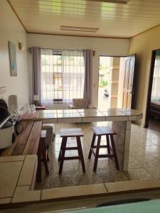 a kitchen with a counter and two stools in a room at Arenal Dreams Apartments in Fortuna +13 photos