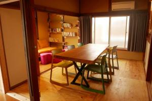 a dining room with a table and some chairs at GROUNDWORK Guesthouse & Lounge in Yugawara +24 photos