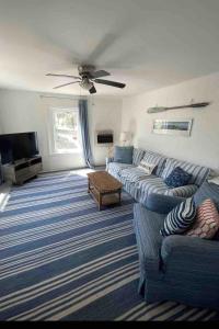 a living room with a couch and a tv at Cottage Apartment by Lake MI w private Hot Tub! 