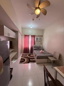 a small room with a bed and a ceiling fan at Sunvida Tower staycation unit 2503-2504 in Cebu City