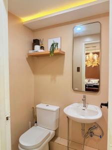 a small bathroom with a toilet and a sink at 2-Bedroom Cozy Haven Sorrento Oasis in Manila +44 photos