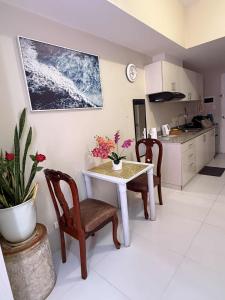 a kitchen with a white table and chairs and a table at Sunvida Tower staycation unit 2503-2504 in Cebu City