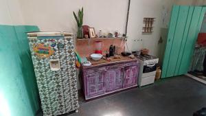 a small kitchen with a refrigerator and a stove at Pelourinho House Experience in Salvador +29 photos