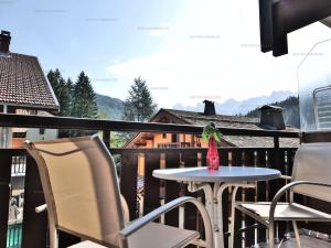a bird sitting on a table on a balcony at Charmant studio 4 pers. au Grand-Bornand, centre du village - FR-1-458-254 in Le Grand-Bornand