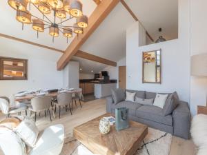 a living room with a couch and a table at Appartement moderne aux pieds des pistes, Alpe d'Huez - FR-1-645-92 in L'Alpe-d'Huez