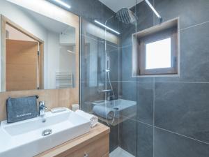 a bathroom with a sink and a shower at Appartement moderne aux pieds des pistes, Alpe d'Huez - FR-1-645-92 in L'Alpe-d'Huez +7 photos
