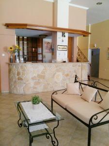a living room with a couch and a table at Asteras hotel in Hanioti