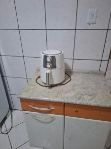 a toaster sitting on top of a counter in a kitchen at Suíte Master in Mossoró