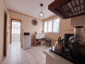 a kitchen with a refrigerator and a sink in it at Gîte Saint Lubin à Cloyes : Confort familial et charme régional - FR-1-581-157 in Cloyes-sur-le-Loir