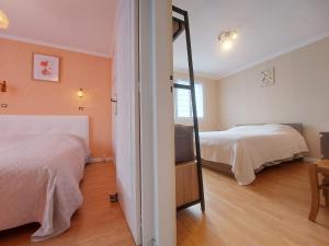 a bedroom with two beds and a mirror at Gîte Saint Lubin à Cloyes : Confort familial et charme régional - FR-1-581-157 in Cloyes-sur-le-Loir
