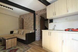 a kitchen and living room with a couch in a room at Coskun apt in Istanbul