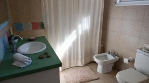a bathroom with a sink and a toilet at Posada El Descanso in Mercedes