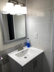 a bathroom with a sink and a mirror at Peaceful and Private Small Room in Brampton +5 photos