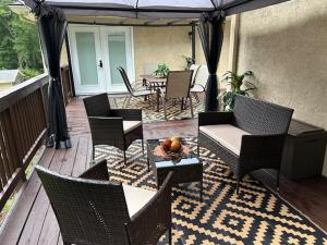 a patio with chairs and a table and an umbrella at Hibiscus Retreat fully equipped guest studio in Fayetteville
