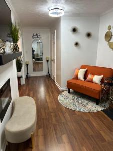 a living room with a couch and a chair at Hibiscus Retreat fully equipped guest studio in Fayetteville