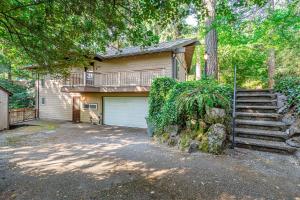 a house with a staircase and a garage at Bellevue Forest Haven Hideaway in Bellevue